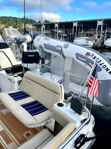 Slide: The Image of 2019 Ranger Tugs R-29S boat with American flag, docked at marina. - 9