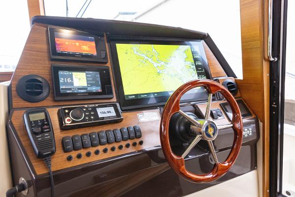 Slide: The Image of 2025 Ranger Tugs R-43 Command Bridge helm with advanced navigation displays and controls. - 12