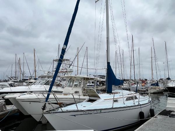 Slide: The Image of 1979 Ranger Yachts 30 sailboat docked in a marina with other boats. - 0