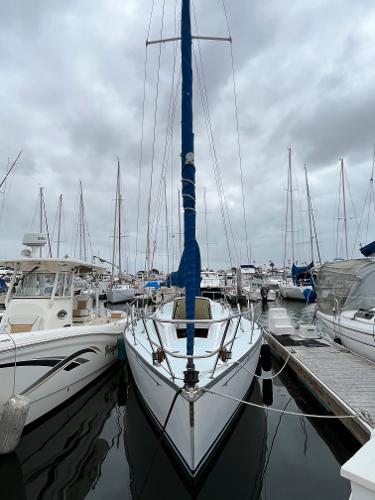Slide: The Image of Alt text: 1979 Ranger Yachts 30 sailboat docked at marina on a cloudy day. - 1