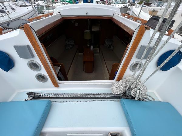 Slide: The Image of 1979 Ranger Yachts 30 sailboat interior view with seating and wooden accents. - 16