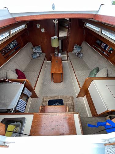Slide: The Image of Interior of a 1979 Ranger Yachts 30 sailboat with cozy seating and wooden furnishings. - 17