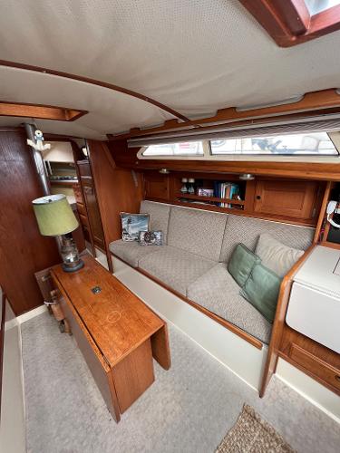 Slide: The Image of 1979 Ranger Yachts 30 interior with cozy seating and wooden cabinetry. - 18