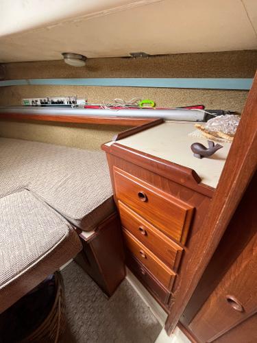 Slide: The Image of Interior cabin of 1979 Ranger Yachts 30 with wooden drawers and cushioned bed. - 30