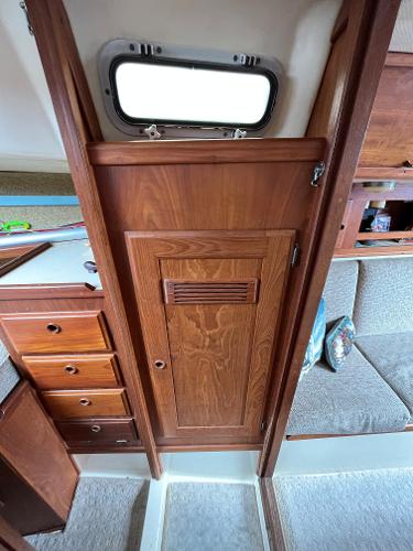 Slide: The Image of Interior of 1979 Ranger Yachts 30, featuring wooden cabinetry and seating area. - 31