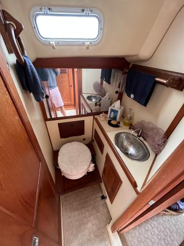 Slide: The Image of 1979 Ranger Yachts 30 bathroom with sink, mirror, and storage. - 33