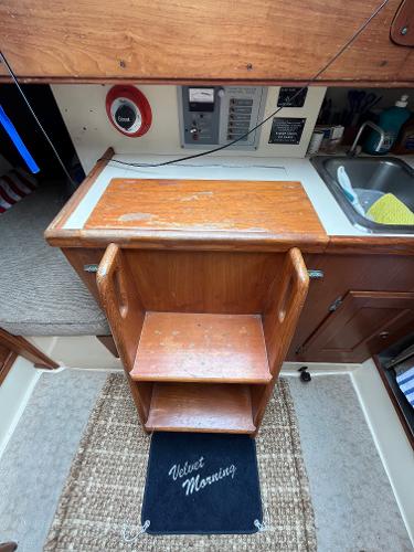 Slide: The Image of 1979 Ranger Yachts 30 interior with wooden steps and kitchen area. - 38