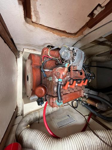 Slide: The Image of 1979 Ranger Yachts 30 engine compartment with visible wiring and hoses. - 42