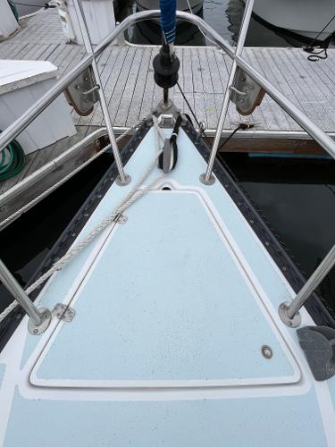 Slide: The Image of Bow of a 1979 Ranger Yachts 30 sailboat docked at a marina. - 5