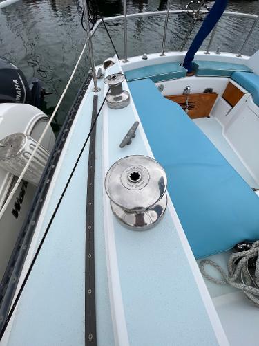 Slide: The Image of 1979 Ranger Yachts 30 sailboat deck with winches and blue seating. - 9