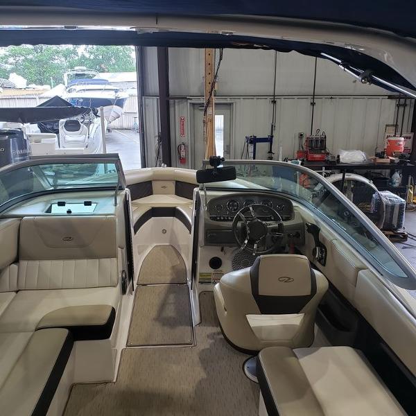 Slide: The Image of Interior of a 2014 Regal 2100 boat in a storage facility. - 1