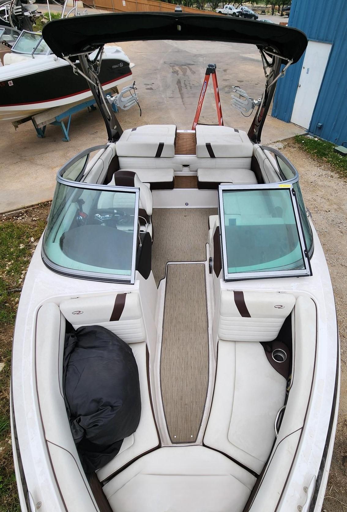 Slide: The Image of 2016 Regal 2100 Bowrider boat with spacious seating and modern design. - 9