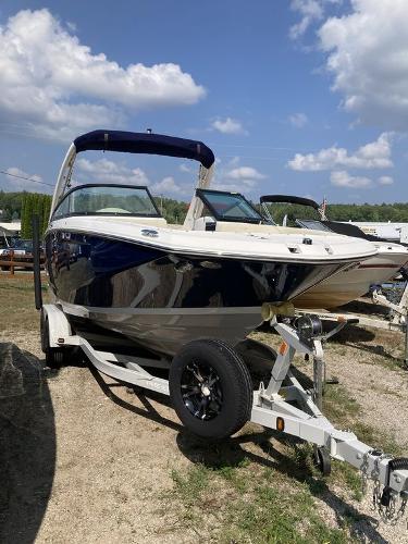 Slide: The Image of 2022 Regal 22 FasDeck boat on trailer under blue sky. - 0