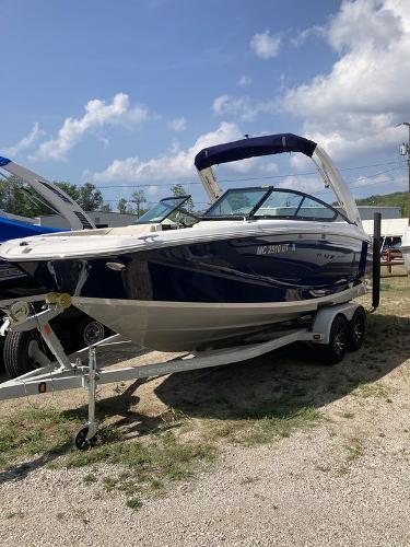 Slide: The Image of 2022 Regal 22 FasDeck boat on trailer under clear sky. - 2