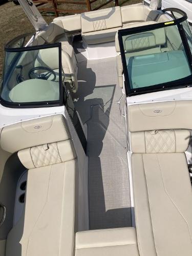 Slide: The Image of 2022 Regal 22 FasDeck boat interior with beige seating and glass windshields. - 6