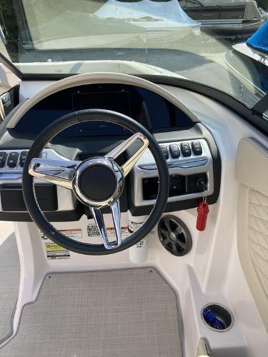Slide: The Image of 2022 Regal 22 FasDeck boat dashboard with steering wheel and controls. - 7
