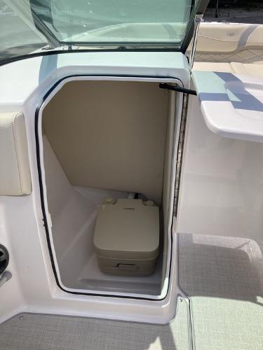 Slide: The Image of 2022 Regal 22 FasDeck boat interior with compact portable toilet. - 9