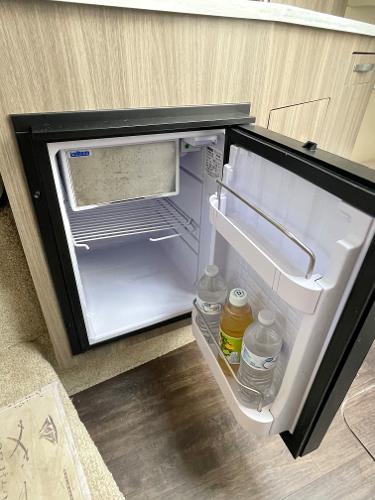 Slide: The Image of Open mini fridge in 2021 Regal 26 Express boat, with drinks inside. - 19