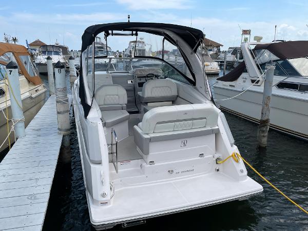 Slide: The Image of 2021 Regal 26 Express boat docked at marina, rear view. - 2