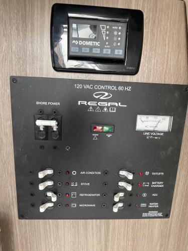 Slide: The Image of Control panel of a 2021 Regal 26 Express boat with various switches and a Dometic display. - 20