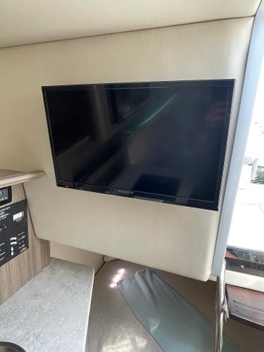Slide: The Image of Flat-screen TV inside 2021 Regal 26 Express boat cabin. - 21