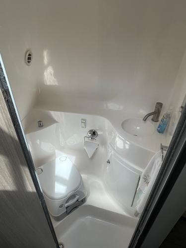 Slide: The Image of 2021 Regal 26 Express bathroom with compact toilet, sink, and modern fixtures. - 23