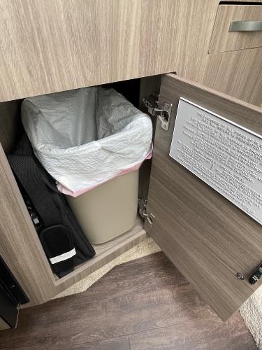Slide: The Image of Cabinet with trash bin inside a 2021 Regal 26 Express boat. - 25