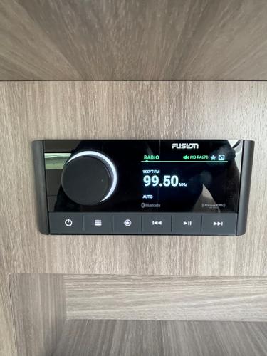 Slide: The Image of Fusion radio display in 2021 Regal 26 Express boat, tuned to 99.50 FM. - 26