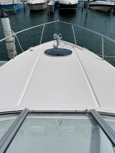 Slide: The Image of 2021 Regal 26 Express boat docked in a marina, viewed from the bow. - 33