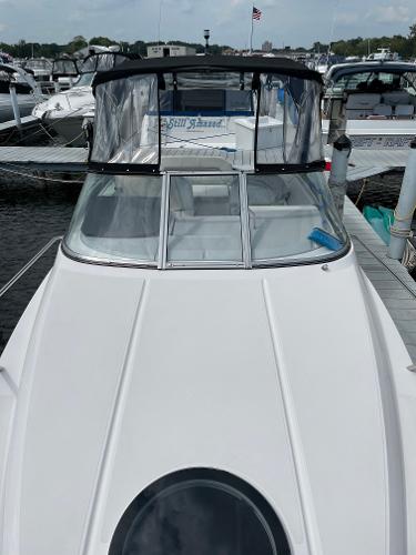 Slide: The Image of 2021 Regal 26 Express boat docked at marina, featuring sleek design and spacious cabin. - 36