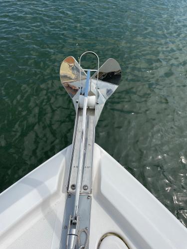 Slide: The Image of 2021 Regal 26 Express boat anchor over calm water. - 38