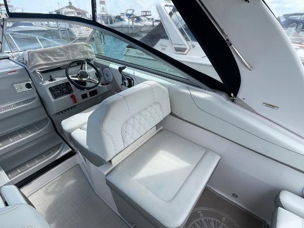 Slide: The Image of 2021 Regal 26 Express boat interior with white seating and steering wheel. - 5