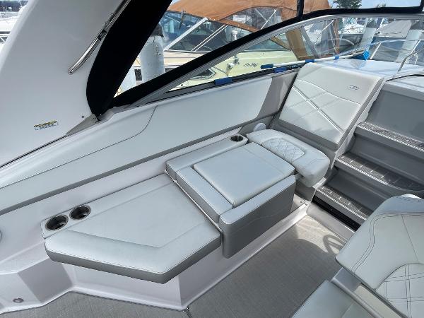 Slide: The Image of 2021 Regal 26 Express boat interior with white seating and cup holders. - 6