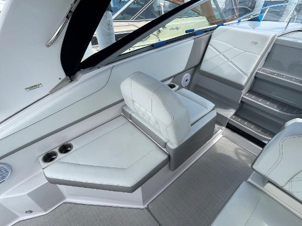 Slide: The Image of 2021 Regal 26 Express boat interior with white seating and cup holders. - 7
