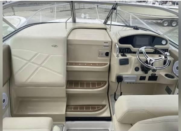 Slide: The Image of Interior view of a 2020 Regal 26 XO boat cockpit with steering wheel and controls. - 11