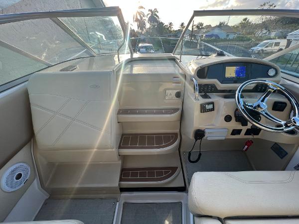 Slide: The Image of 2020 Regal 26 XO boat cockpit with steering wheel and dashboard controls. - 12