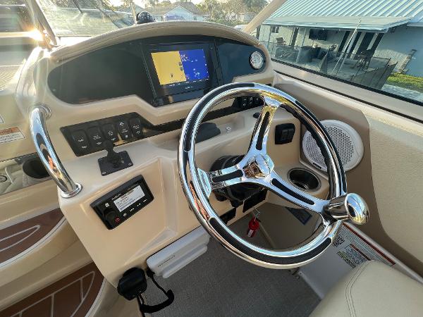Slide: The Image of 2020 Regal 26 XO boat dashboard with steering wheel and navigation display. - 14