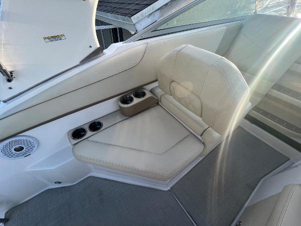 Slide: The Image of 2020 Regal 26 XO boat interior with beige seating and cup holders. - 19
