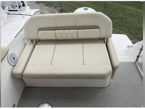 Slide: The Image of 2020 Regal 26 XO boat with beige cushioned seating and backrest. - 21