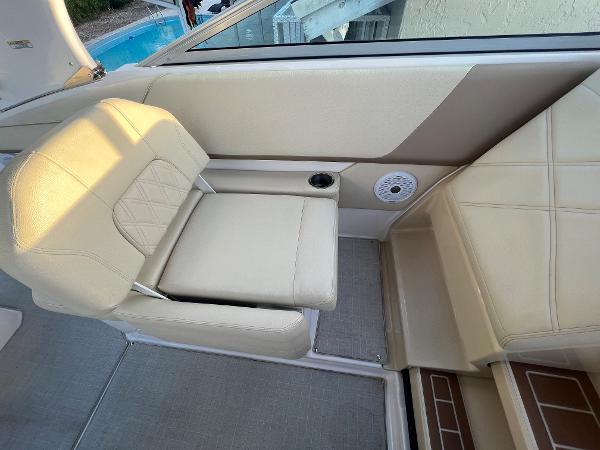 Slide: The Image of 2020 Regal 26 XO boat interior with beige seating and cup holder. - 22