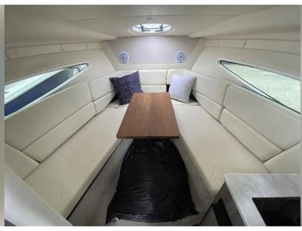 Slide: The Image of 2020 Regal 26 XO cabin interior with seating, table, and cushions. - 29
