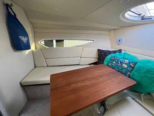 Slide: The Image of Cozy interior of 2020 Regal 26 XO boat with wooden table and cushioned seating. - 31