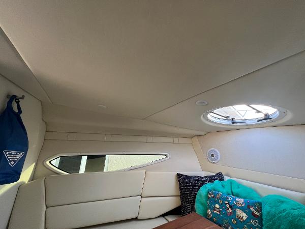Slide: The Image of Interior of 2020 Regal 26 XO boat with cozy seating and porthole window. - 33