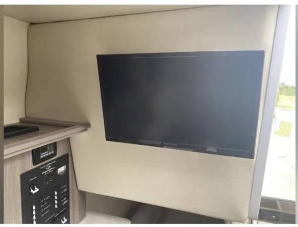 Slide: The Image of Interior of 2020 Regal 26 XO boat featuring a mounted flat-screen TV. - 39