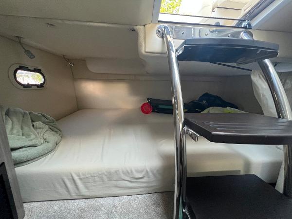 Slide: The Image of 2020 Regal 26 XO cabin interior with bed and ladder, featuring a small window. - 41