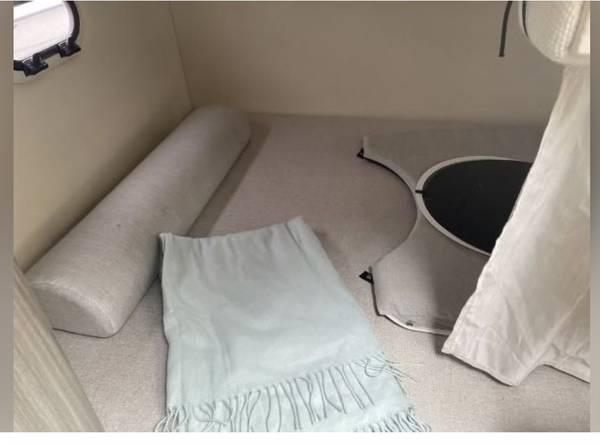Slide: The Image of 2020 Regal 26 XO cabin interior with cushions and a light blue blanket. - 42
