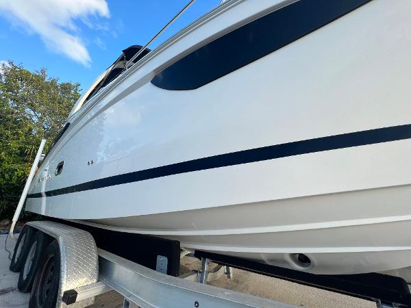 Slide: The Image of 2020 Regal 26 XO boat on trailer, side view under blue sky. - 5