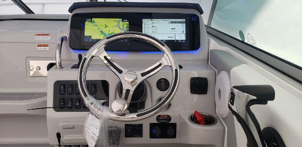 Slide: The Image of Helm of 2025 Regal 26 XO boat with modern navigation system and controls. - 1