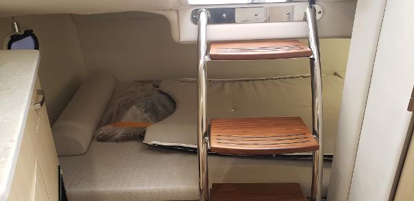 Slide: The Image of Interior cabin of 2025 Regal 26 XO boat with wooden steps and seating area. - 13