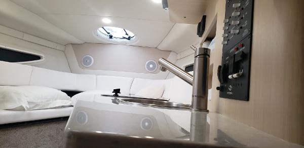 Slide: The Image of Interior of 2025 Regal 26 XO boat, featuring modern kitchen and cozy seating area. - 15